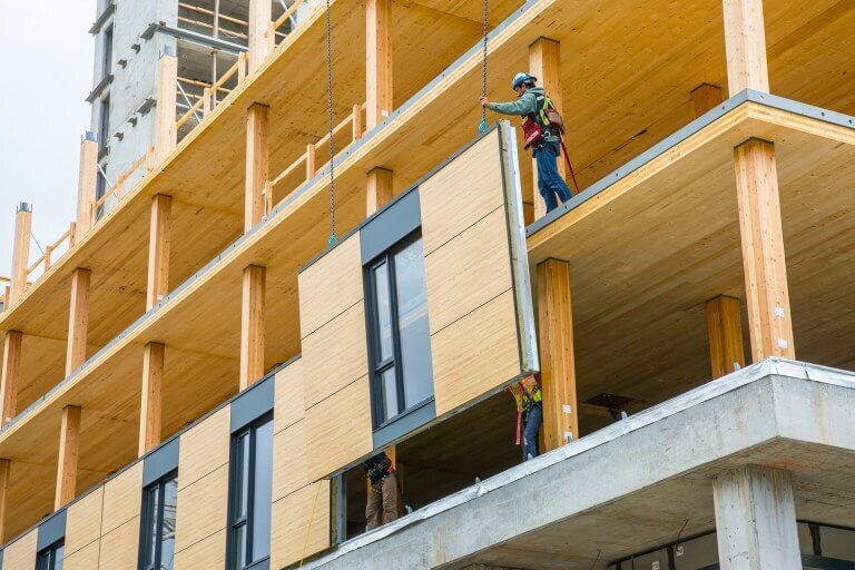 Workers install a CLT panel for Brock Commons in Vancouver. (Credit: Naturally Wood )