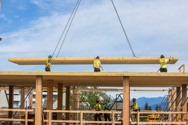 A CLT floor panel being set in place. (Credit: Naturally Wood )